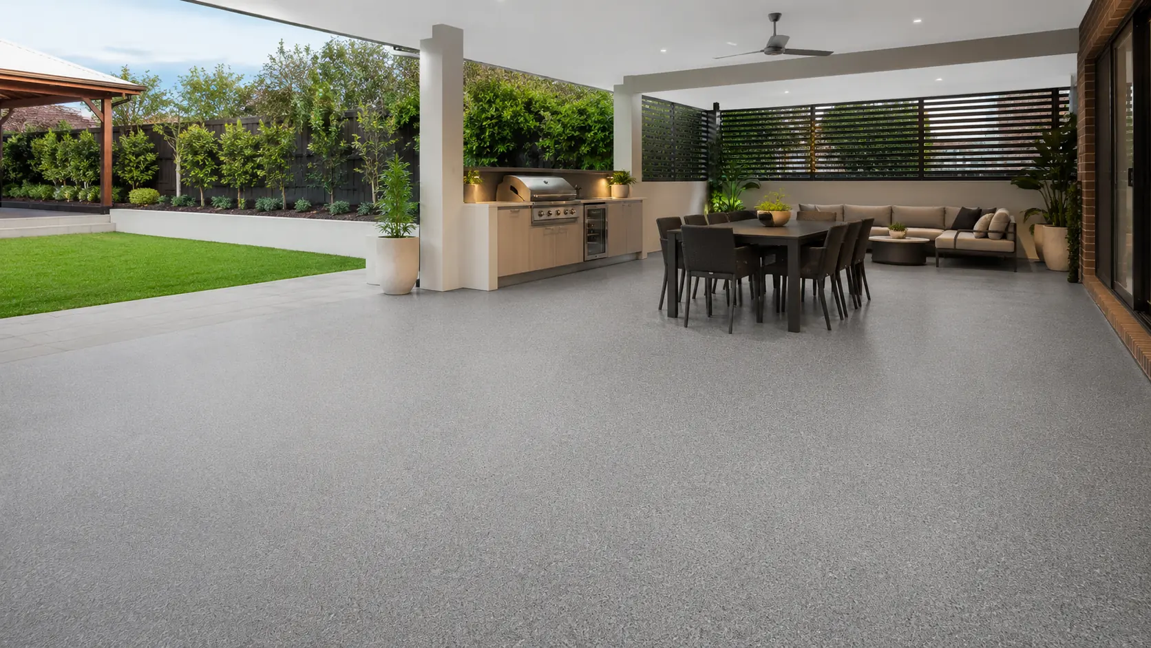 Covered Australian alfresco area with a matte light grey decorative flake floor, illustrating flake flooring options in Melbourne.
