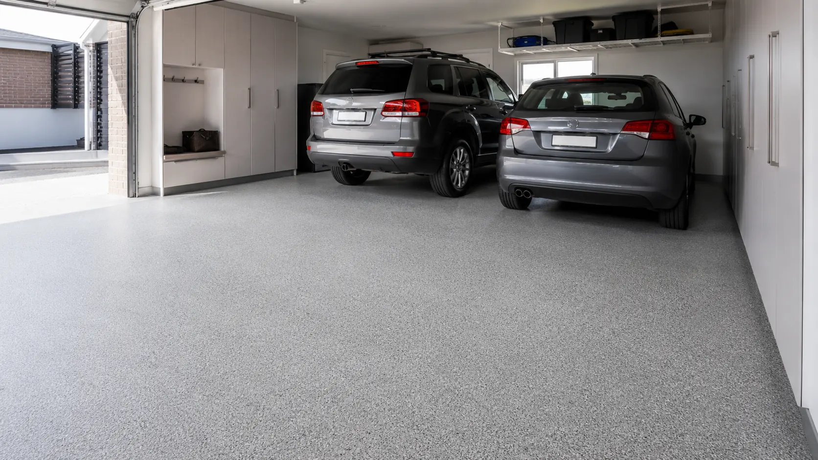 Modern double garage with a matte light and medium grey flake epoxy floor, illustrating garage flooring available in Melbourne.